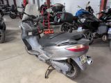 many motorcycles parked in a garage next to each other