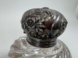 a glass jar with a silver lid on a table