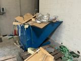 a blue dumpster sitting in the middle of a room