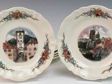two plates with a picture of a castle on them on a table