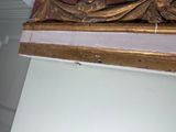 a picture of a gold and white clock on a wall