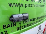a close up of a green van with a sign on the side