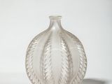 a clear glass vase sitting on a white surface