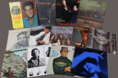 many different album covers on the table together