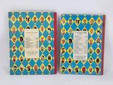 two children ' s books are lined up on a white surface