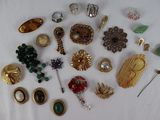 a lot of brooches and pins on a table