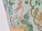 a vase that has a bird and flowers on it