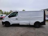 a white van parked in a parking lot next to other cars