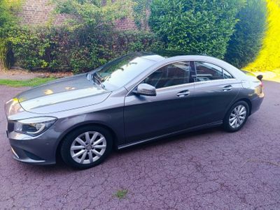 the mercedes cla is parked on the side of the road