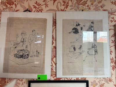 two framed pictures on the wall above a laptop