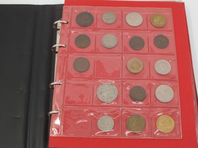 a red binder with a lot of coins inside of it