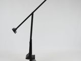 an image of a black desk lamp with a cord attached to it