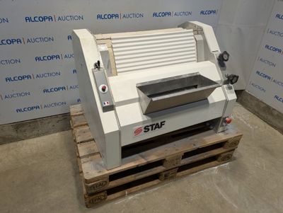 the machine is sitting on a pallet in front of a wall