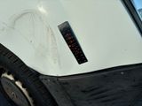 a white car with a sticker on the side of it