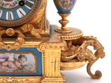 a gold clock with a picture of a baby on it