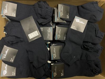 many pairs of socks in a box with labels on them