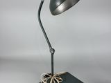 an image of a green desk lamp on a black base
