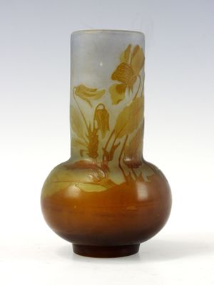 a glass vase with a painting on it sitting on a table