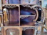 a wooden cabinet that has a clock on top of it