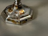 a silver candle that is sitting on a table