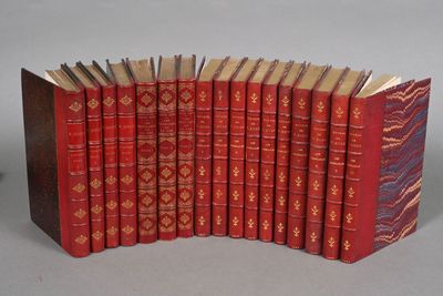 several red books are lined up in a row on a table