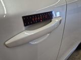 a close up of a car door handle with a sticker on it