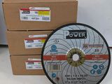two pieces of metal grinding discs sitting on top of cardboard boxes