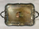 an antique silver tray with a coin in the middle of it
