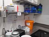 many plates and bowls on the counter in the kitchen