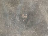 a close up of a metal plate with a number on it