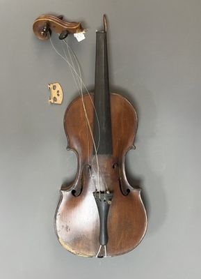 a violin hanging on the wall with a string attached to it