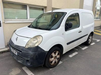 a white van parked in a parking space next to a building