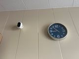 a clock that is on the wall next to a cup
