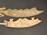 two different types of knives that are on a table
