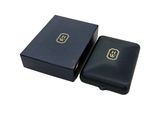 a black leather wallet with a gold logo on the front
