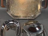 three silver plated dishes and a tray on a table