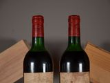 two bottles of wine sitting on top of a table next to a wooden box