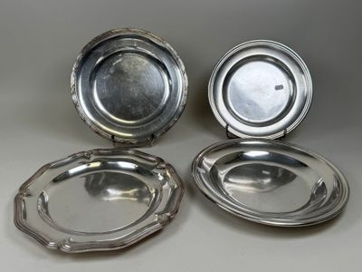 three silverplated dishes on a table, one with a lid and the other with a silver plate