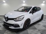 a white car is parked in a room with a checkered floor