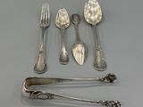 a lot of spoons and forks that are on the table