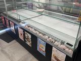 a glass display case with a lot of desserts on it