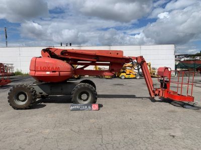 a red crane that is parked in a parking lot