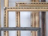 many frames that are lined up on the wall