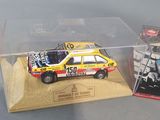 two toy cars in a display case on a table