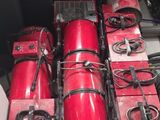 many red fire hydrants in the back of a truck