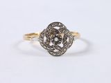 a close up of a gold and diamond ring on a white background