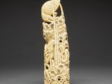 a carved ivory figurine of a woman and a bird