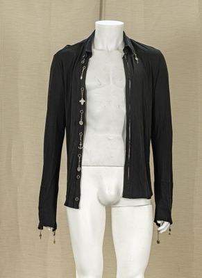 a mannequin wearing a black jacket and white pants