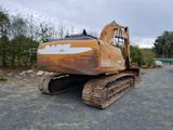 une photo d'un gros bulldozer marron et blanc dans un parking