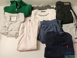 several pairs of clothes are laid out on a white table
